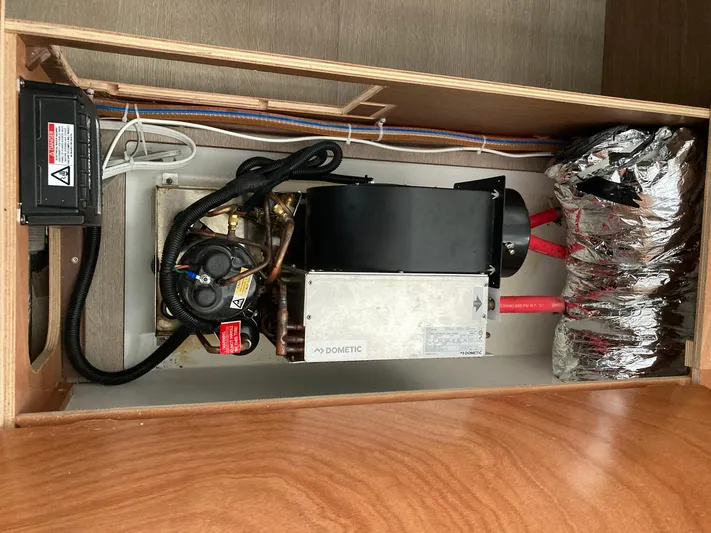 Vela Yacht Photos Pics Engine compartment of a 2018 Lagoon 42 yacht, featuring a Dometic unit and insulated pipes.