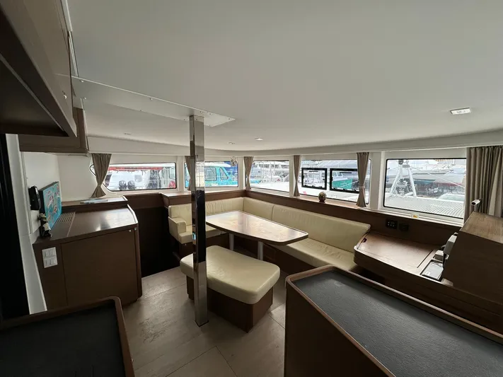 Vela Yacht Photos Pics Interior of 2018 Lagoon 42 catamaran with spacious seating and large windows.