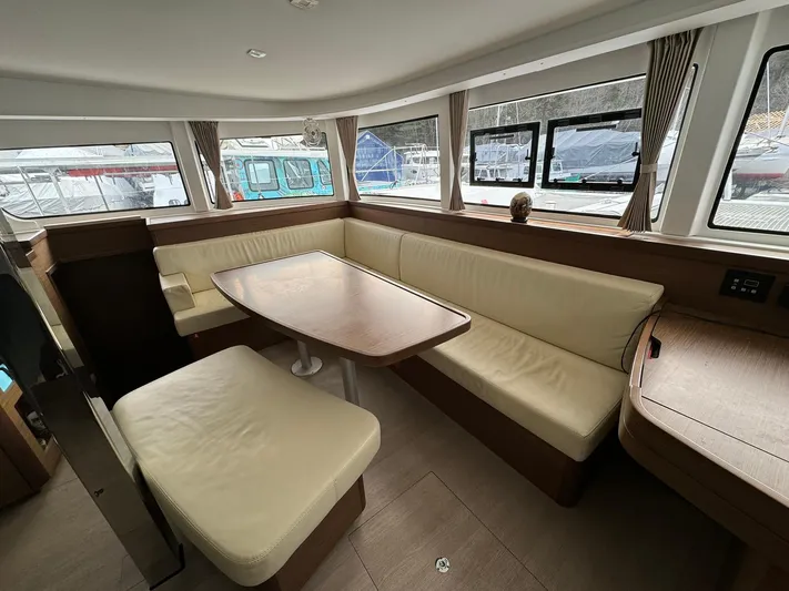 Vela Yacht Photos Pics Interior of 2018 Lagoon 42 catamaran with spacious seating and large windows.