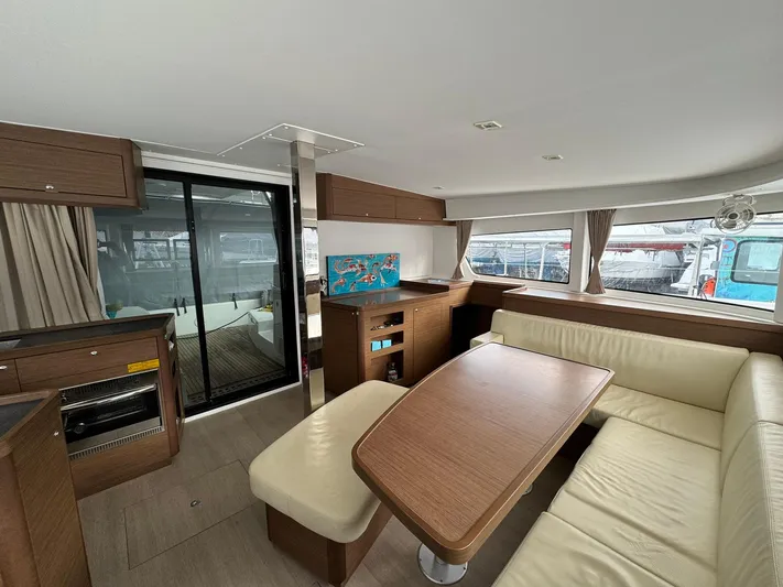 Vela Yacht Photos Pics Interior of 2018 Lagoon 42 catamaran with modern dining area and beige seating.