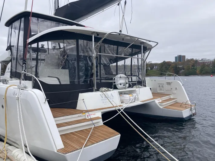 Vela Yacht Photos Pics 2018 Lagoon 42 catamaran docked, featuring spacious deck and modern design.