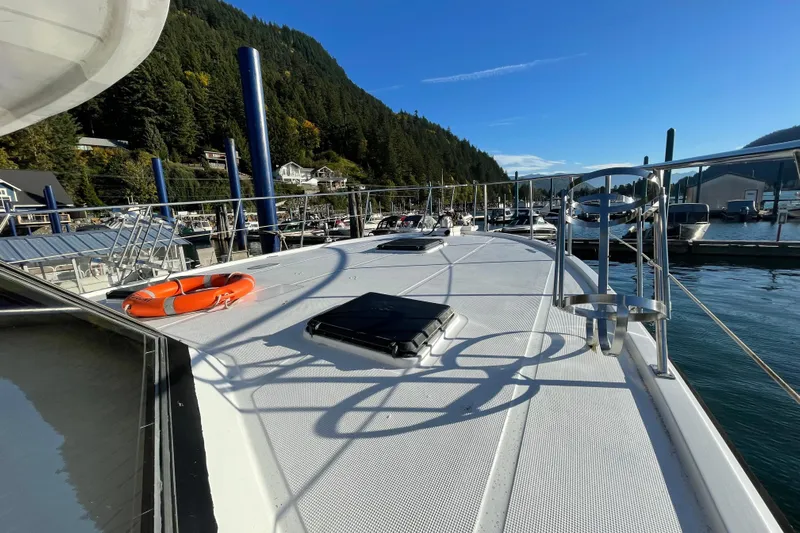 Hasta La Vista Yacht Photos Pics 1997 Symbol 48 Sportfish yacht docked in scenic marina with clear blue sky.