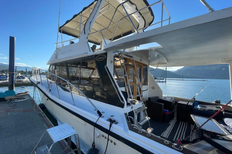 Hasta La Vista Yacht Photos Pics 1997 Symbol 48 Sportfish yacht docked, featuring spacious deck and seating area.