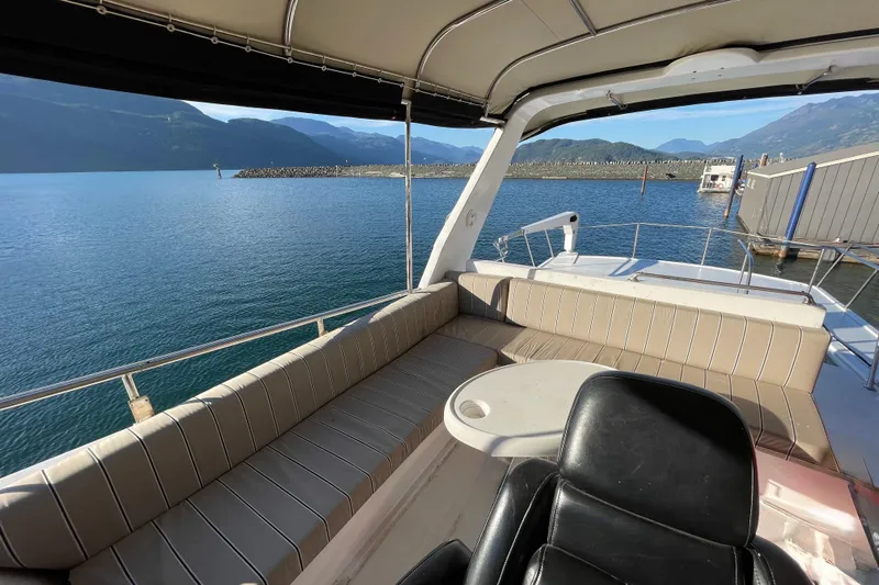 Hasta La Vista Yacht Photos Pics 1997 Symbol 48 Sportfish boat interior with seating, table, and scenic water view.