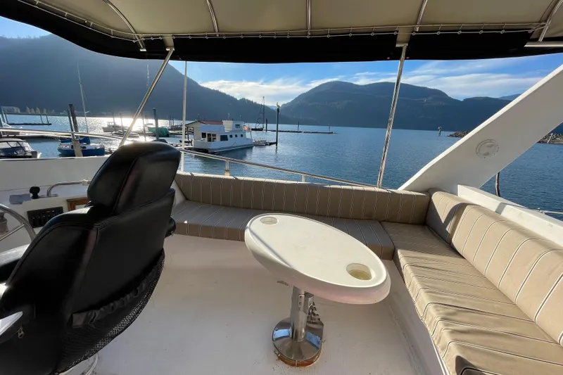 Hasta La Vista Yacht Photos Pics 1997 Symbol 48 Sportfish yacht interior with seating, table, and scenic marina view.