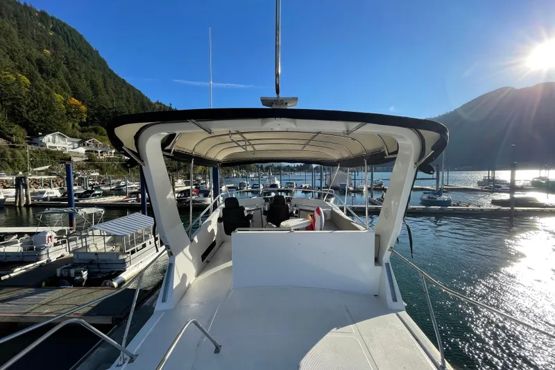 Hasta La Vista Yacht Photos Pics 1997 Symbol 48 Sportfish yacht docked in scenic marina with sunlit water.