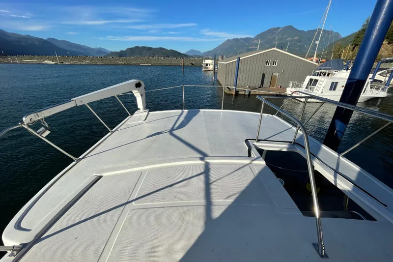 Hasta La Vista Yacht Photos Pics 1997 Symbol 48 Sportfish yacht deck with scenic mountain and marina view.