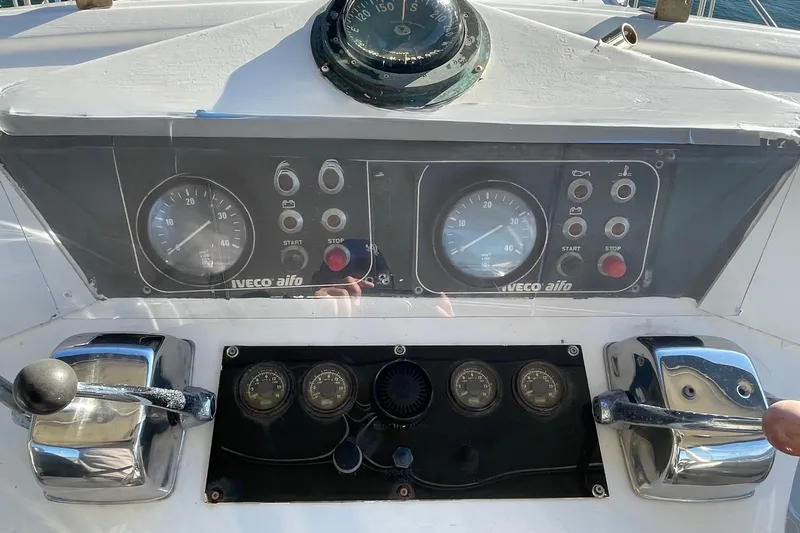 Hasta La Vista Yacht Photos Pics Control panel of a 1997 Symbol 48 Sportfish boat with gauges and levers.