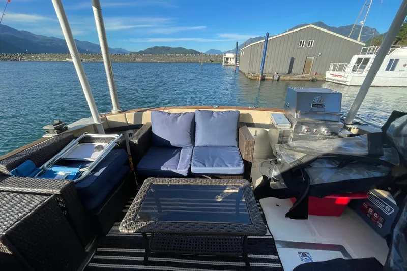 Hasta La Vista Yacht Photos Pics 1997 Symbol 48 Sportfish boat with outdoor seating, grill, and scenic marina view.