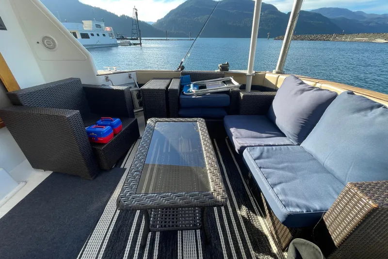 Hasta La Vista Yacht Photos Pics Outdoor seating area on 1997 Symbol 48 Sportfish yacht with scenic water view.