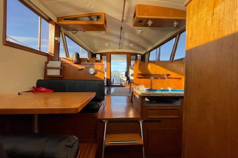 Hasta La Vista Yacht Photos Pics Interior of a 1997 Symbol 48 Sportfish boat with wooden furnishings and seating area.