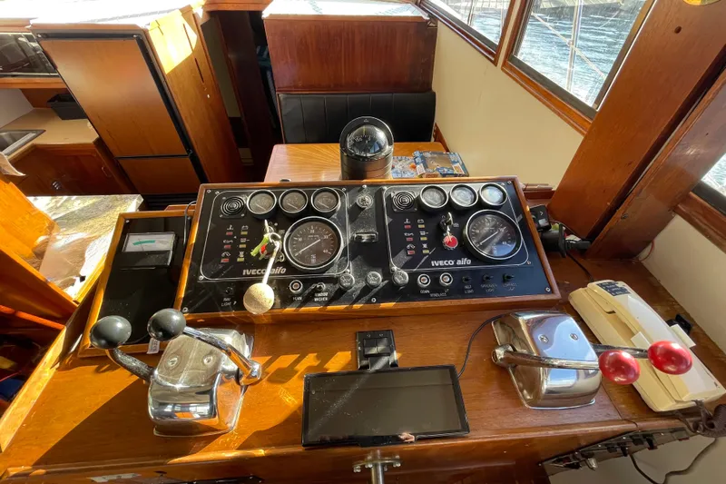 Hasta La Vista Yacht Photos Pics Control panel of a 1997 Symbol 48 Sportfish boat with gauges and levers.