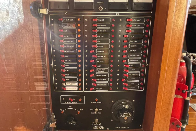Hasta La Vista Yacht Photos Pics Electrical panel of a 1997 Symbol 48 Sportfish boat with labeled switches and controls.