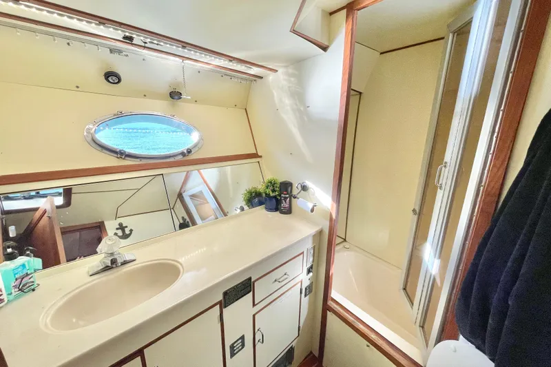 Hasta La Vista Yacht Photos Pics Bathroom interior of 1997 Symbol 48 Sportfish yacht with sink and shower.
