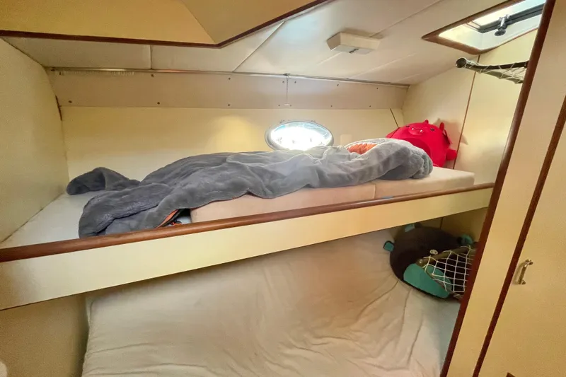Hasta La Vista Yacht Photos Pics Cozy cabin interior of 1997 Symbol 48 Sportfish with bunk beds and porthole.
