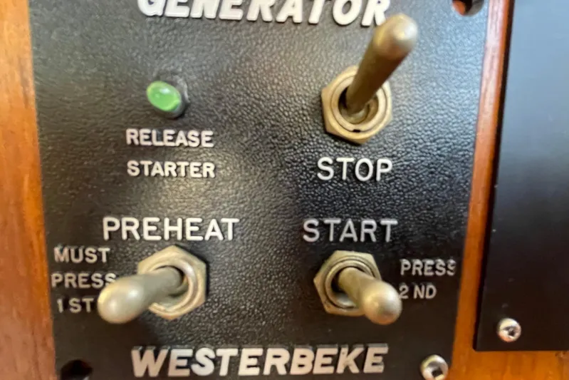 Hasta La Vista Yacht Photos Pics Control panel of a 1997 Symbol 48 Sportfish generator with preheat, start, and stop switches.