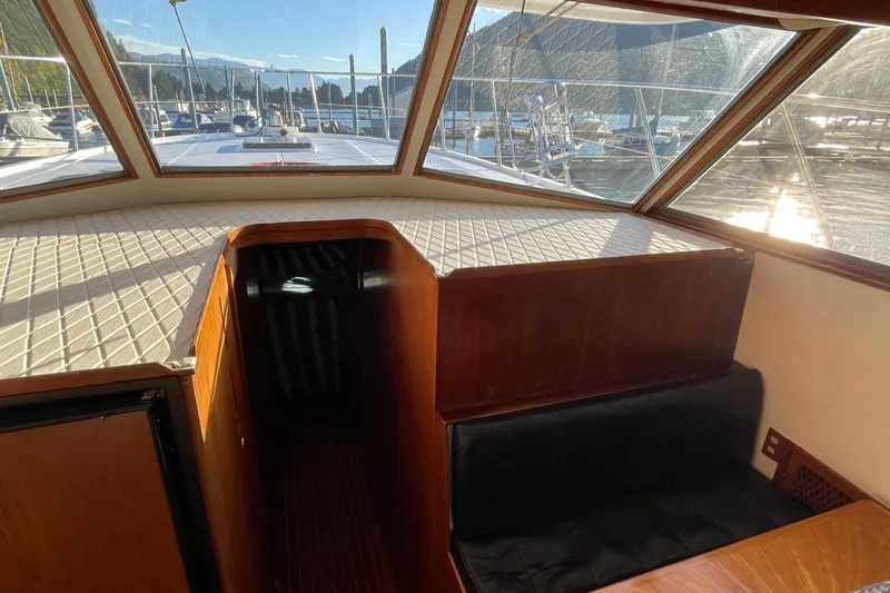 Hasta La Vista Yacht Photos Pics Interior view of 1997 Symbol 48 Sportfish yacht with sunlit cabin and marina backdrop.
