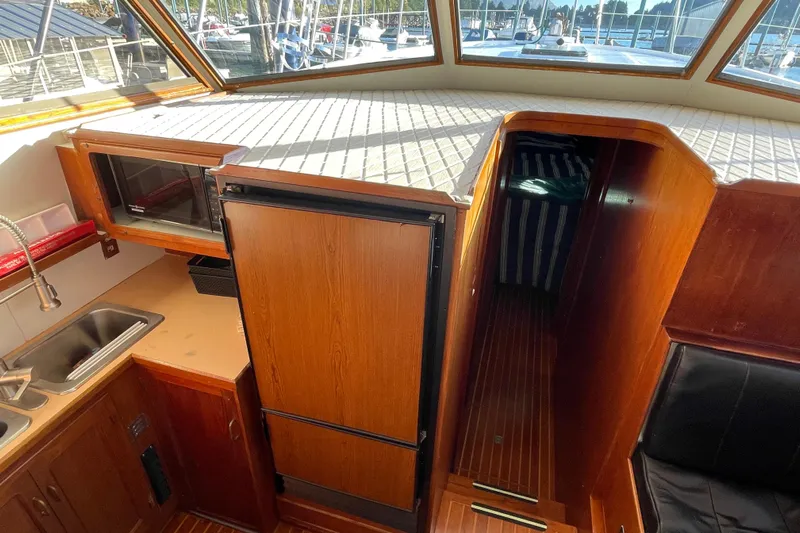 Hasta La Vista Yacht Photos Pics Interior of a 1997 Symbol 48 Sportfish yacht with kitchenette and cabin entrance.