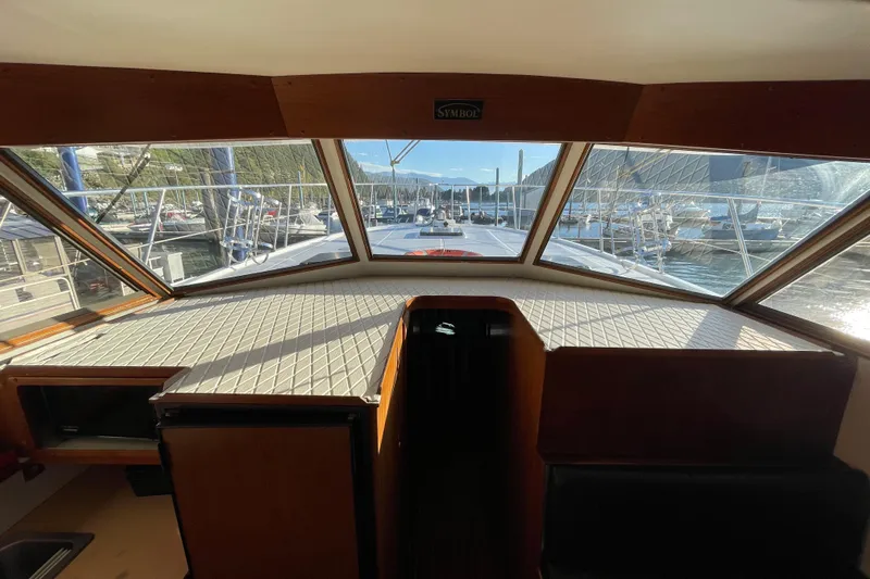Hasta La Vista Yacht Photos Pics Interior view of 1997 Symbol 48 Sportfish yacht with marina backdrop.