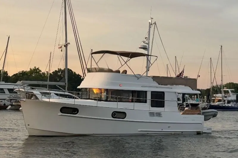  Yacht Photos Pics 2018 Beneteau Swift Trawler 44 yacht docked at sunset, surrounded by sailboats.