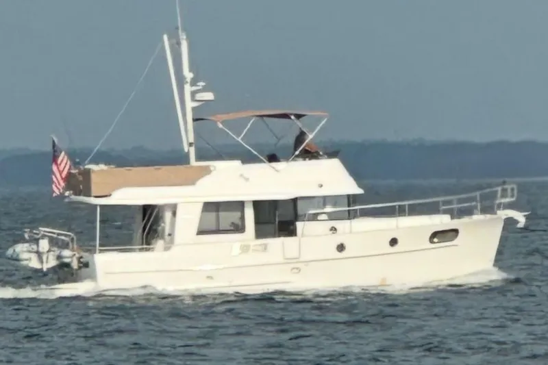  Yacht Photos Pics 2018 Beneteau Swift Trawler 44 cruising on open water, side view.