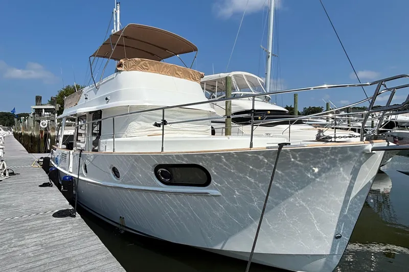  Yacht Photos Pics 2018 Beneteau Swift Trawler 44 docked at marina under clear blue sky.