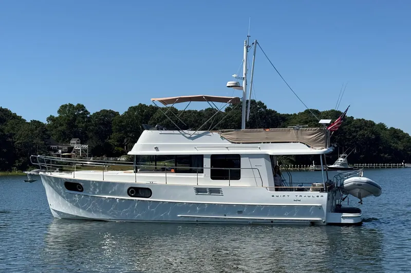  Yacht Photos Pics 2018 Beneteau Swift Trawler 44 on calm water, side view with clear sky.