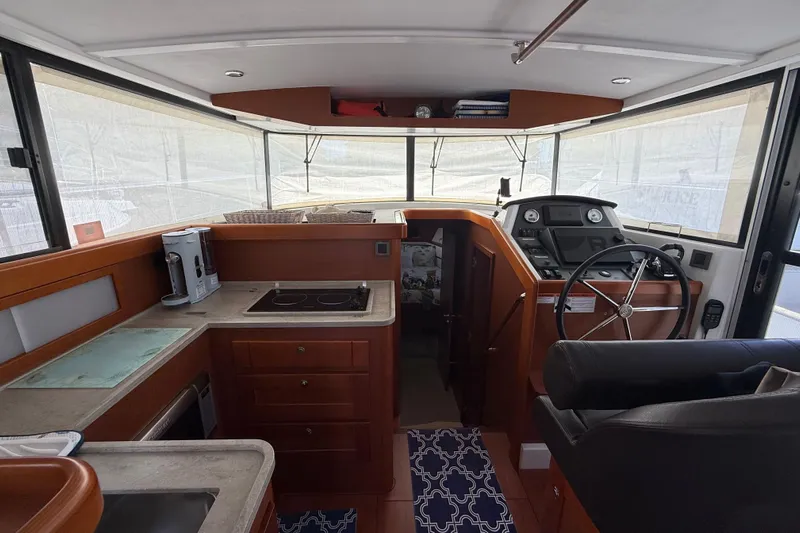  Yacht Photos Pics 2018 Beneteau Swift Trawler 44 interior with helm, kitchen, and modern amenities.