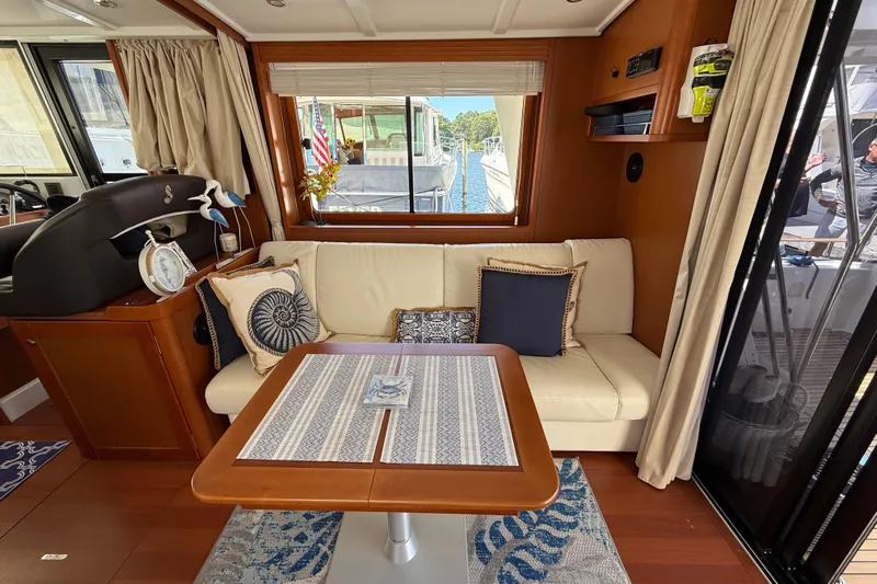  Yacht Photos Pics Interior of 2018 Beneteau Swift Trawler 44 with cozy seating and nautical decor.