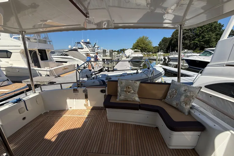  Yacht Photos Pics 2018 Beneteau Swift Trawler 44, elegant deck with cushioned seating, docked at marina.