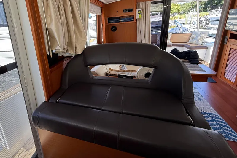  Yacht Photos Pics Interior of 2018 Beneteau Swift Trawler 44 with leather seating and wooden accents.