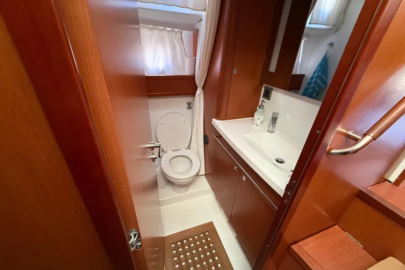  Yacht Photos Pics 2018 Beneteau Swift Trawler 44 bathroom with wooden cabinetry and modern fixtures.