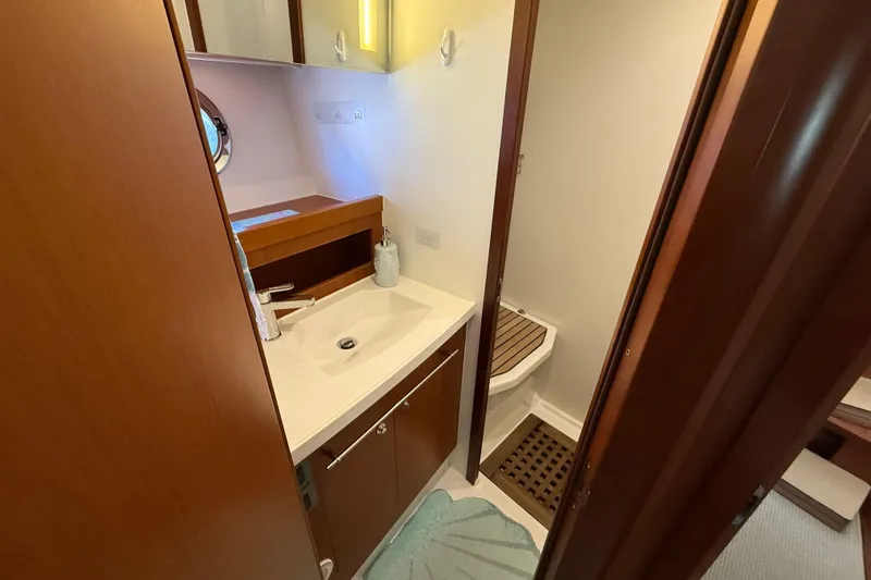  Yacht Photos Pics 2018 Beneteau Swift Trawler 44 bathroom with modern sink and wooden accents.