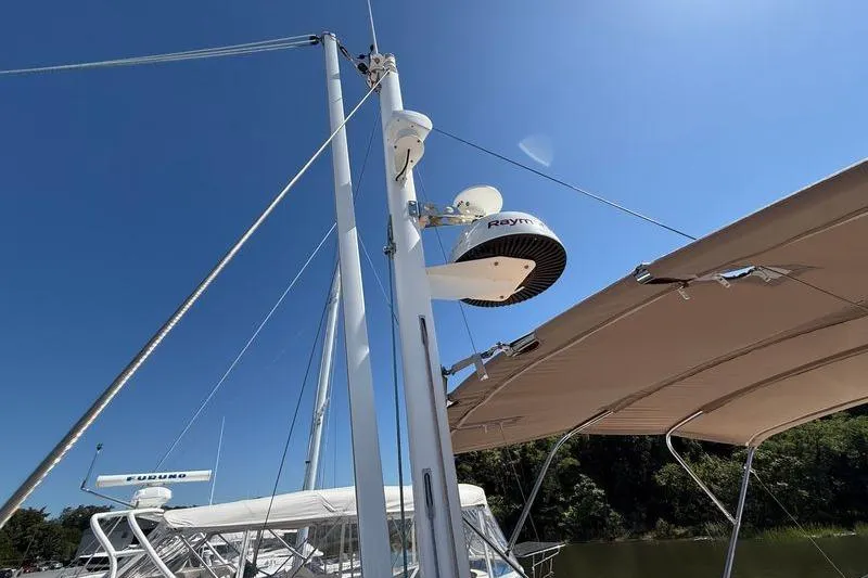  Yacht Photos Pics 2018 Beneteau Swift Trawler 44 with radar equipment and canopy under clear blue sky.