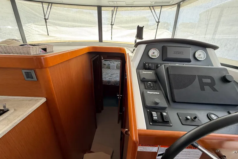  Yacht Photos Pics 2018 Beneteau Swift Trawler 44 helm with navigation controls and cabin view.