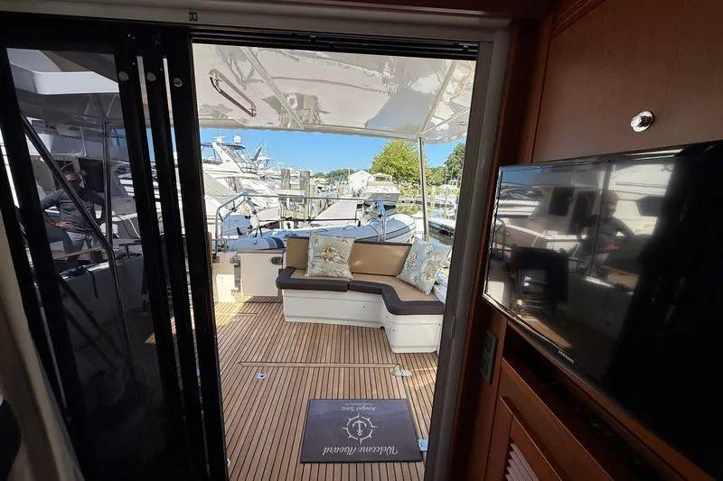  Yacht Photos Pics 2018 Beneteau Swift Trawler 44 interior with outdoor seating and marina view.
