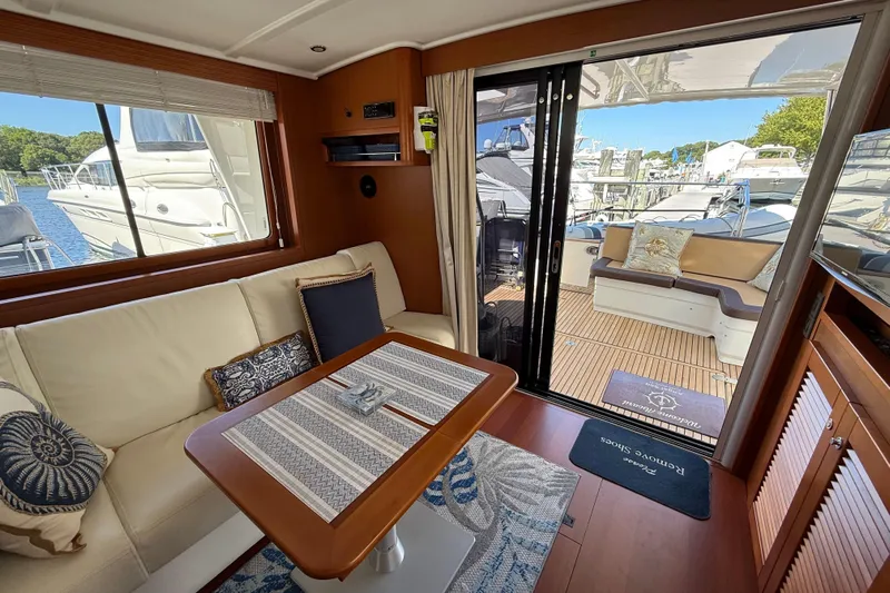  Yacht Photos Pics Interior of 2018 Beneteau Swift Trawler 44, featuring cozy seating and elegant wood finishes.