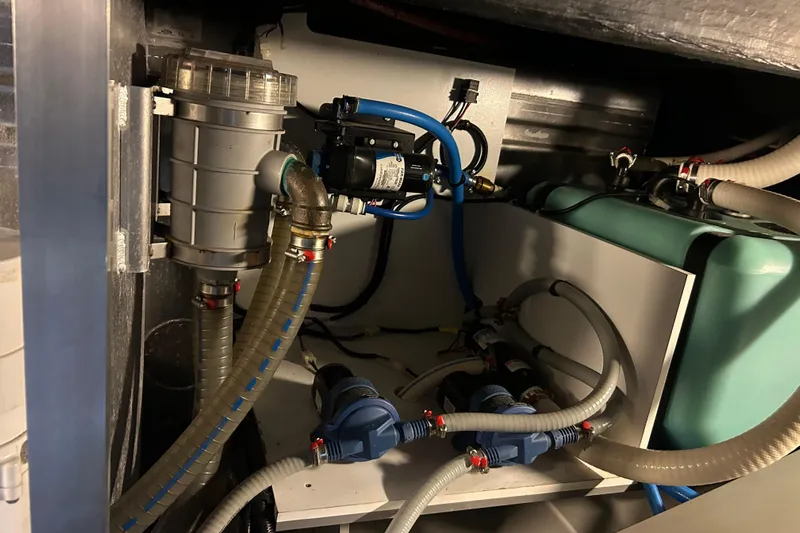  Yacht Photos Pics Engine room of 2018 Beneteau Swift Trawler 44 with visible plumbing and machinery.