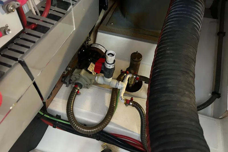  Yacht Photos Pics Engine compartment of 2018 Beneteau Swift Trawler 44, showcasing mechanical components and hoses.