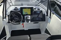 2022 Iron 827 T-Top boat dashboard with steering wheel and navigation system.