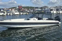 2022 Iron 827 T-Top boat docked in a marina with other vessels.
