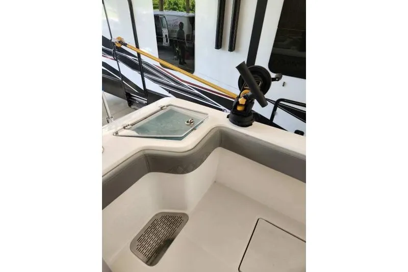 Yacht Photos Pics 2023 Front Runner 36 cc boat interior with rod holder and storage compartment.