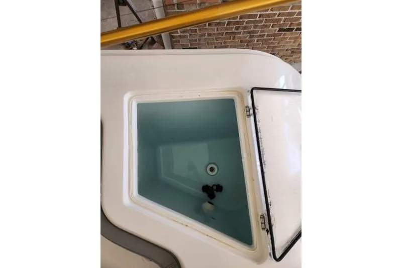  Yacht Photos Pics Open storage compartment on 2023 Front Runner 36 cc boat, showing interior details.