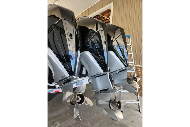  Yacht Photos Pics Three 2023 Front Runner 36 cc outboard motors with propellers, displayed in a garage setting.