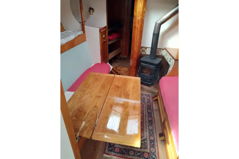 Martha Primrose Yacht Photos Pics Cozy interior of 2012 Custom Mayflower 50 boat with wood stove and dining area.