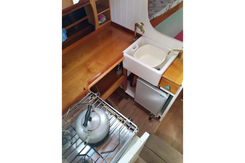 Martha Primrose Yacht Photos Pics Compact kitchen area in a 2012 Custom Mayflower 50 boat, featuring a sink and stove.