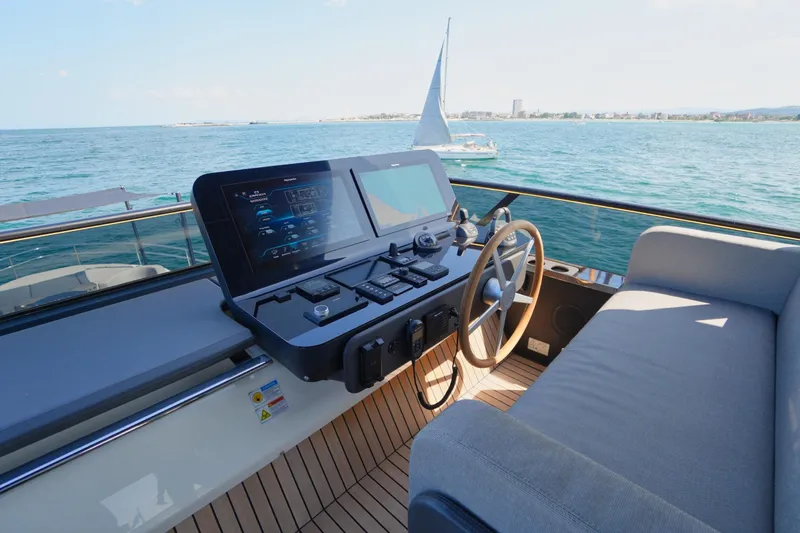 Amy Yacht Photos Pics 2023 Cranchi Sessantasette 67 yacht helm with modern controls, overlooking the ocean.