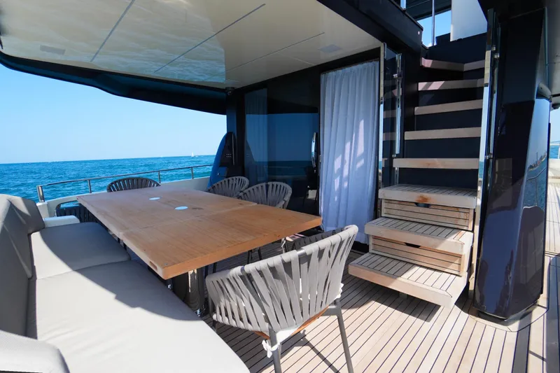 Amy Yacht Photos Pics Luxury deck of 2023 Cranchi Sessantasette 67 yacht with dining area and ocean view.