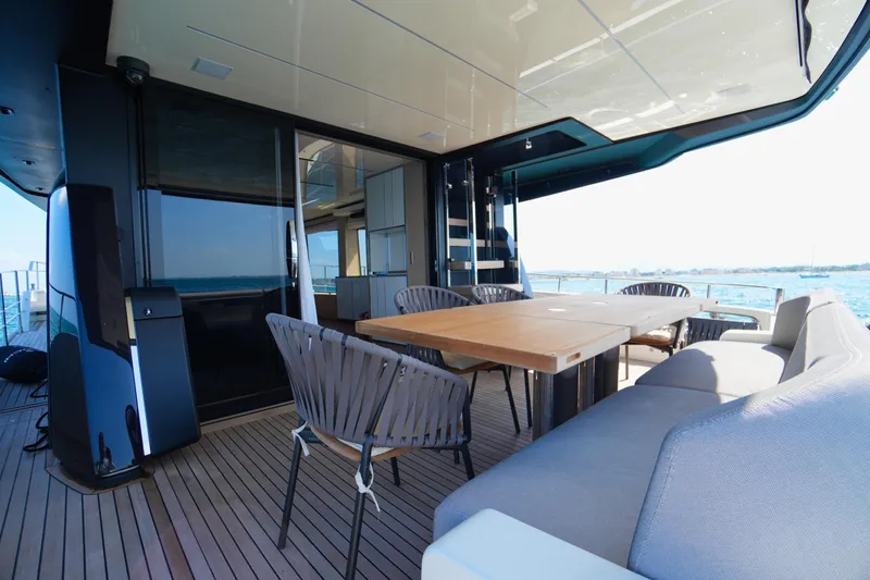 Amy Yacht Photos Pics Luxurious deck of 2023 Cranchi Sessantasette 67 yacht with elegant seating and dining area.