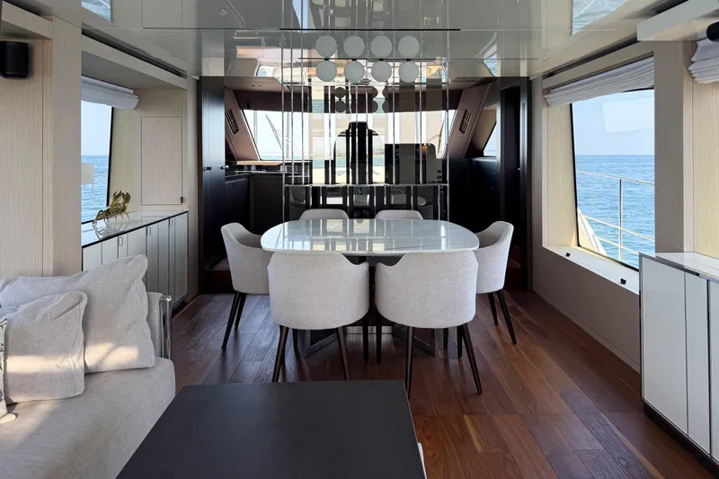 Amy Yacht Photos Pics Luxurious interior of 2023 Cranchi Sessantasette 67 yacht with elegant dining area and ocean view.